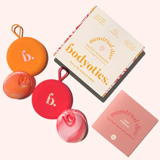 Bodyotics reusable menstrual discs with orange and red silicone cases, packaging box, and user manual.